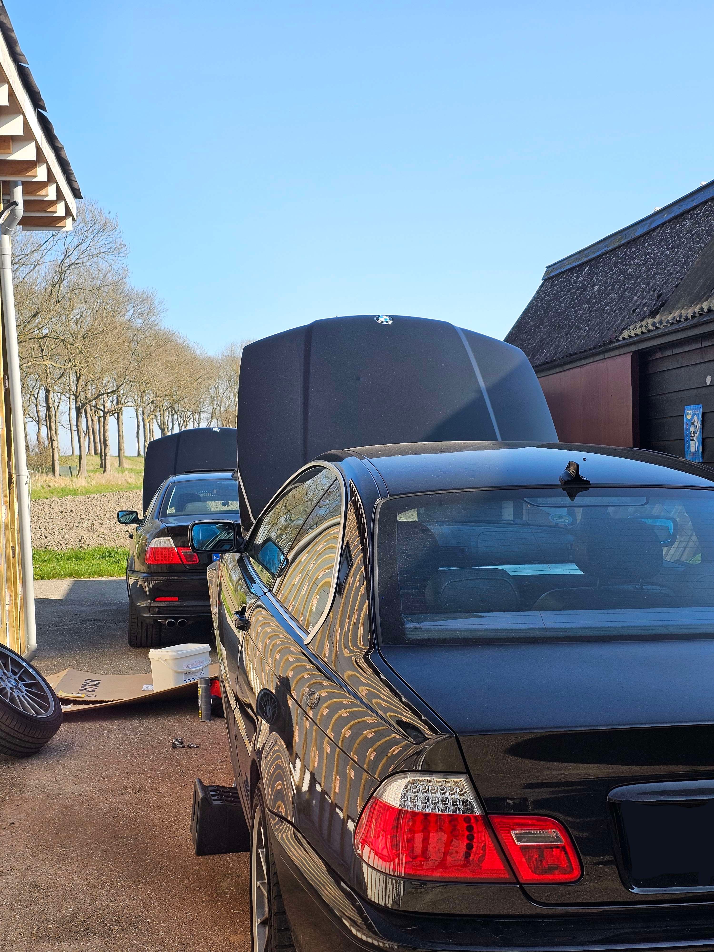 De E46 op assteunen achter de schuur, midden in een sleutelklus
